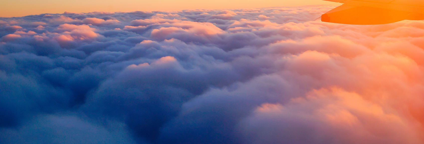 Airplane Wing in Flight from window, sunset sky