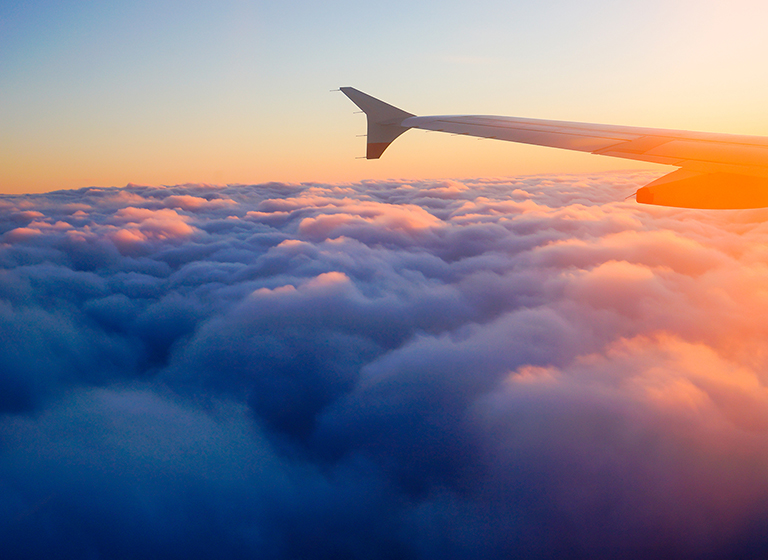 Airplane Wing in Flight from window, sunset sky