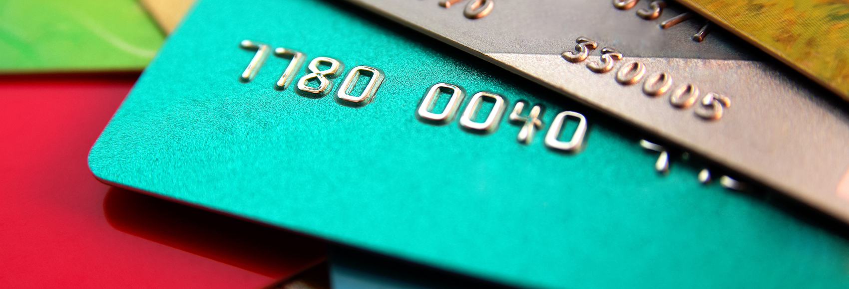 stack of multicolored credit cards, close up view with selective focus